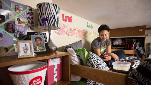 Smiling student in residence hall room