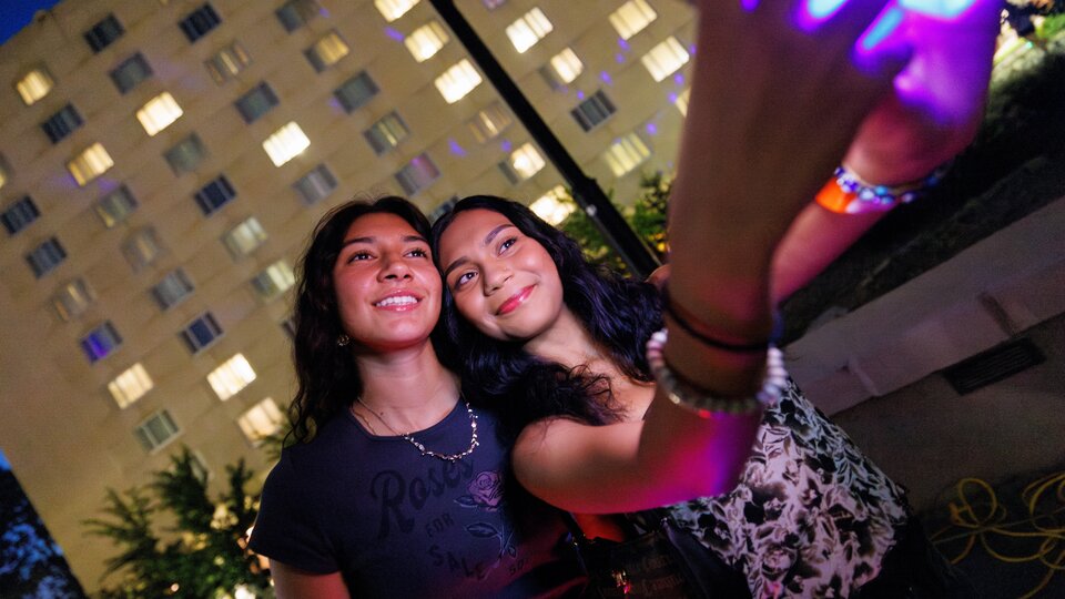 Two students taking a picture while enjoying an on-campus event.